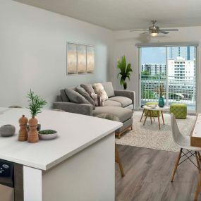 Living room with lighted ceiling fan and wood inspired flooring at Camden Brickell Apartments in Miami, FL.