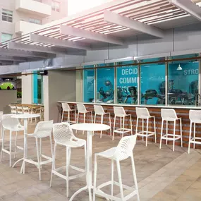 Poolside dining and social areas at Camden Brickell apartments in Miami, FL