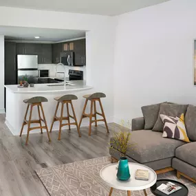 Open concept kitchen with quartz countertops and energy efficient stainless steel appliances at Camden Brickell Apartments in Miami, FL.