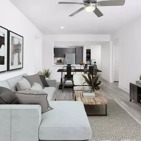 Living, dining, and kitchen with wood-style flooring and ceiling fan at Camden Brickell apartments in Miami, FL