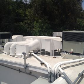 Rooftop packaged HVAC unit - ducts painted with insulating sun shield.