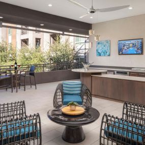Camden Tempe Apartments Tempe Arizona Outdoor Resident Lounge with Seating Area and Catering Kitchen with TV