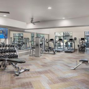 Camden Tempe Apartments Tempe Arizona 24-Hour Fitness Center with Dumbbells, Strength Training Machines, and Cardio under high ceilings