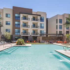 Camden Tempe West Apartments in Tempe Arizona west pool amenity with sun deck and loungers near barbecue grill and corn hole
