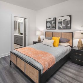 Camden Tempe West Apartments in Tempe Arizona main bedroom with contemporary woodlike flooring and ensuite bathroom