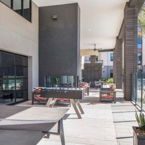 Camden Tempe West Apartments in Tempe Arizona outdoor resident lounge game area with ping pong and foosball tables