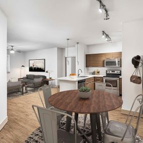 Dining area with decorative nook track lighting and wood look flooring