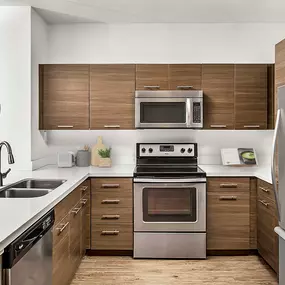 Kitchen with quartz countertops stainless steel appliances and glass cooktop