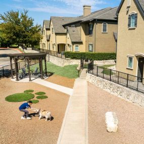 Aerial view of the dog park with resident playing with their dog at Camden Shadow Brook