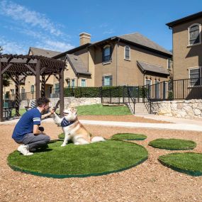 Resident high-fiving their dog at the Camden Shadow Brook dog park