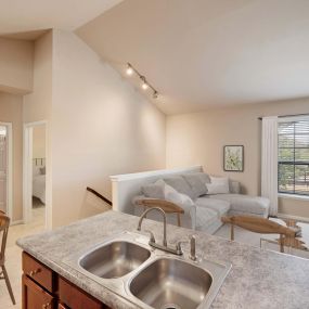 Second floor living room, dining area, and bedroom and bathroom with interior staircase at Camden Shadow Brook in Austin, TX