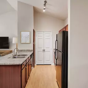 Second floor kitchen with vaulted ceilings and pantry closet at Camden Shadow Brook in Austin, TX