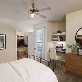 Bedroom with carpet, built-in desk, and walk-in closet at Camden Shadow Brook in Austin, TX