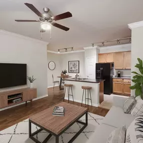 First floor living room, kitchen with island, and dining area at Camden Shadow Brook in Austin, TX