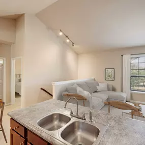 Second floor living room, dining area, and bedroom and bathroom with interior staircase at Camden Shadow Brook in Austin, TX