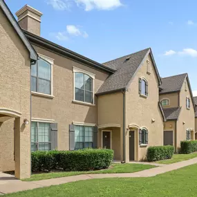 Exterior building view showing all first floor front doors at Camden Shadow Brook apartments in Austin, TX