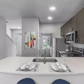 Townhome floor plan kitchen with quartz countertops stainless steel appliances and undermount sink