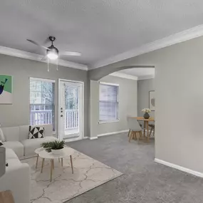 Living and dining area with crown molding ceiling fan and access to private balcony