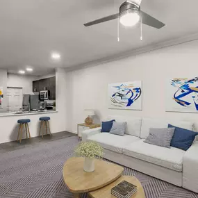 Townhome floor plan living room with crown molding wood look flooring and ceiling fan