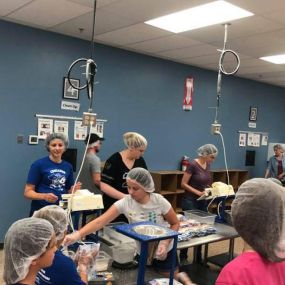 Student volunteers at Feed My Starving Children. At Ave Maria Academy, students engage in daily acts of charity that may take place within the school or extend to communities around the world.