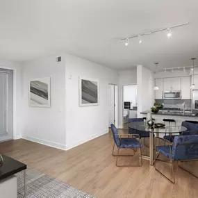 Dining area alongside kitchen with island and pendant lighting