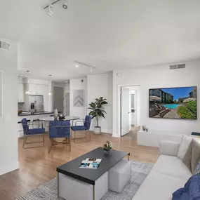 Open concept floor plan living and dining area with wood look flooring