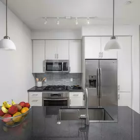 Kitchen with granite countertops stainless steel appliances and gas cooktop