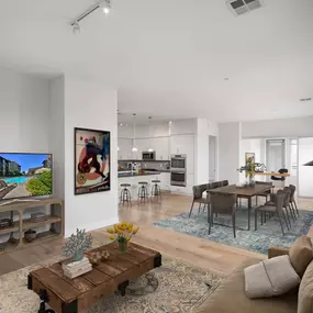 Penthouse open concept living and dining area alongside kitchen