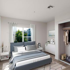 Bedroom with closet with sliding doors and wood look flooring