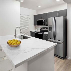 camden tuscany apartments san diego ca kitchen with barstool seating and stainless steel appliance