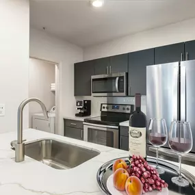 Kitchen along side laundry room with full size washer and dryer