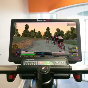 24 hour fitness center with virtual trainer on stationary bikes