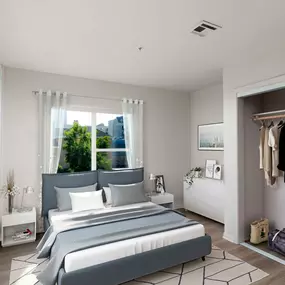 Bedroom with closet with sliding doors and wood look flooring