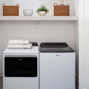 Full-size washer and dryer with built-in storage shelf