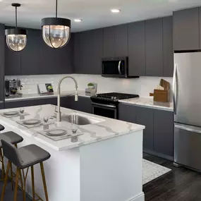 Modern gray kitchen with kitchen island and white quartz countertops