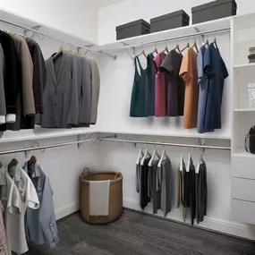 Modern gray closet with built-in shelving and drawers