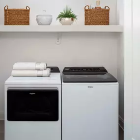 Full-size washer and dryer with built-in storage shelf