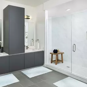 Penthouse bathroom with modern gray finishes, double sink, and walk-in shower at Camden Buckhead in atlanta GA