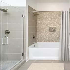 Penthouse bathroom with walk-in, frameless shower and separate bath