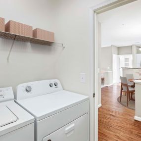Laundry room with full size washer and dryer in apartment