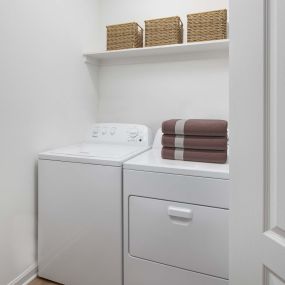 Contemporary style laundry rooms are spacious and feature shelves for additional storage space.