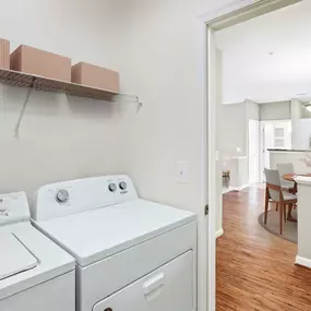 Laundry room with full size washer and dryer in apartment