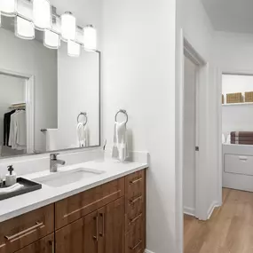 Bathroom with under-mount sink and access to the laundry room at Camden Fair Lakes Apartments in Fairfax, VA.