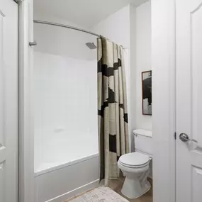 One bedroom en-suite bathroom with a garden bathtub and standing shower at Camden Fair Lakes Apartments in Fairfax, VA.