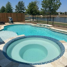 Freeform pool with tanning ledge and spa