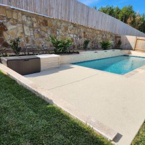 Custom pool with retaining wall and scuppers