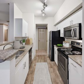 Kitchen with stainless steel appliances at Camden Holly Springs Apartments in Houston, TX
