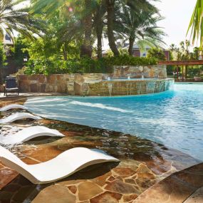 Resort style pool with tanning shelf wifi water features and grills at Camden Holly Springs Apartments in Houston, TX