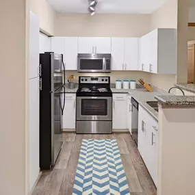 Kitchen with white shaker cabinets at Camden Holly Springs Apartments in Houston, TX