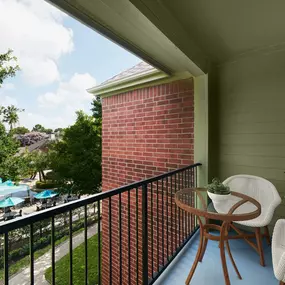 Balcony overlooking the resort-style pool at Camden Holly Springs Apartments in Houston, TX